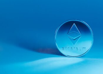 Cryptocurrency logo with Ethereum symbol and hacker visual elements illustrating illicit transactions.