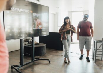 Cango team celebrates in front of a screen displaying Ecohash AI platform growth metrics.