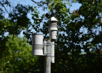 Weather sensor equipment displayed with police tools in a regulatory setting.