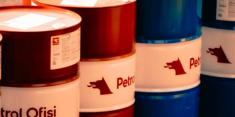 Oil barrels with rising price graphs, highlighting surging oil prices amid geopolitical tensions.