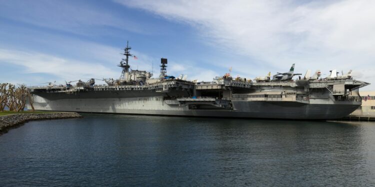 US Navy ships lined up off the coast, highlighting the oil supply disruption and price spike.