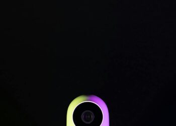 Xiaomi MiMo 2.5 Pro AI device featuring vision sensors against a colorful tech backdrop.