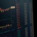 A digital representation of a Kraken logo overlaid on financial charts and cybersecurity symbols.