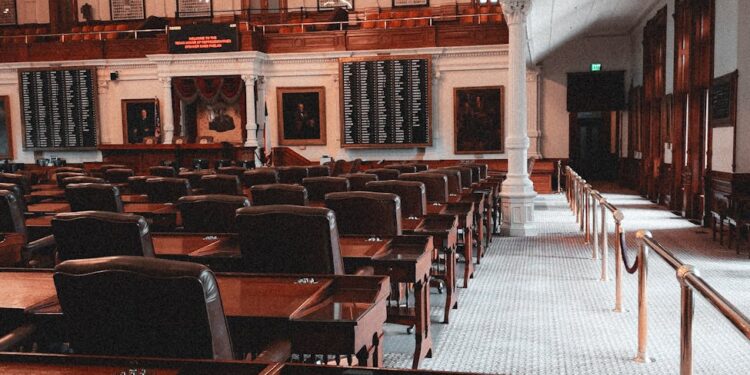 Legislators discussing AI surveillance warrant regulations in a government meeting room.
