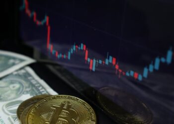 Goldman Sachs logo with Bitcoin and financial charts in the background, symbolizing ETF strategy.