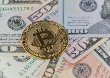 Bitcoin price graph trending upwards with an overlay of dollar bills and ETF symbols.