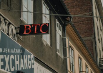 Australian government building with cryptocurrency symbols, highlighting new exchange regulations.