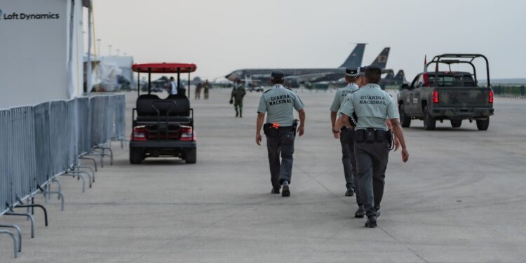 Li Xiong, chair of the Huione Group, escorted by officials at an airport for extradition to China.
