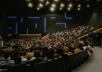 Large crowd at a cryptocurrency conference, with banners promoting Ripple's Swell 2026 event.