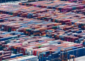 Freight containers at a shipping yard, symbolizing tokenization in real-world assets.