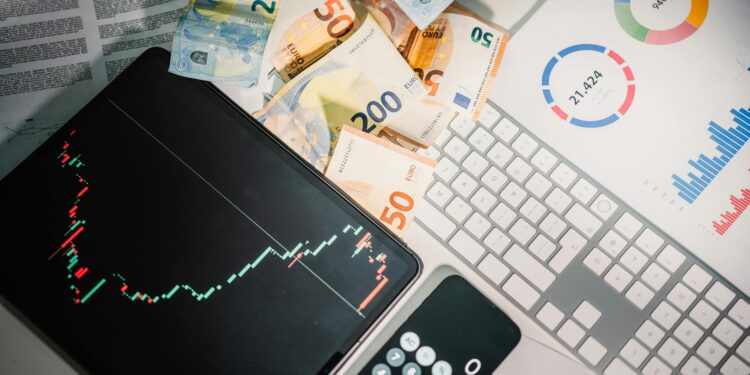 EDX Markets logo displayed with U.S. currency and regulatory documents on a desk.