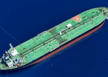 Oil tanker navigating through the Strait of Hormuz, symbolizing rising Brent Crude prices.