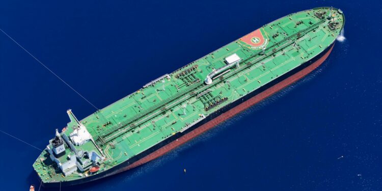 Oil tanker navigating through the Strait of Hormuz, symbolizing rising Brent Crude prices.