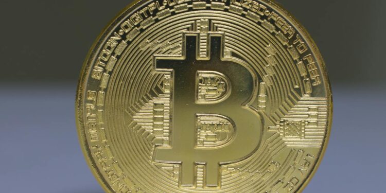 A Bitcoin coin stands strong against oil barrels, symbolizing market resilience amidst Iran tensions.