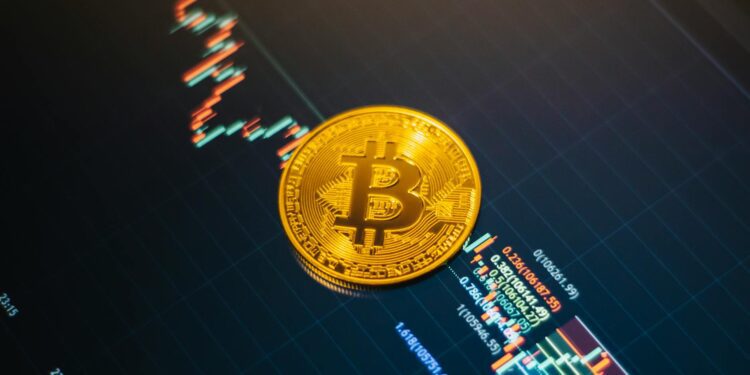 A close-up of Bitcoin and other cryptocurrencies on a financial chart background.