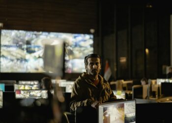 Military personnel monitor a Bitcoin node on screens in a command center.