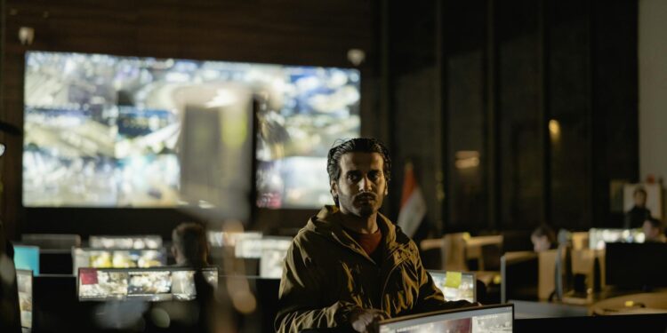 Military personnel monitor a Bitcoin node on screens in a command center.