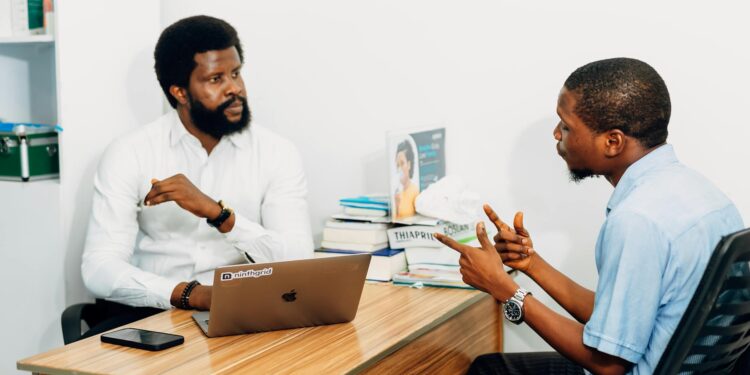 Two professionals discussing blockchain technology and AI in a modern office setting.