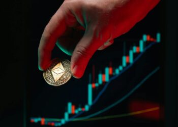 Crypto trader analyzes Ethereum charts with financial graphs in the background.