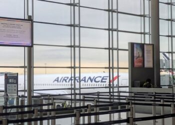 Passenger tampering with a weather sensor using a hair dryer at a Paris airport.