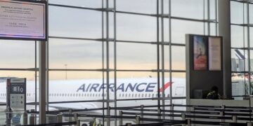 Passenger tampering with a weather sensor using a hair dryer at a Paris airport.