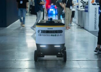 Alibaba team showcasing the new AI model Qwen 3.6-Max-Preview at a tech conference.