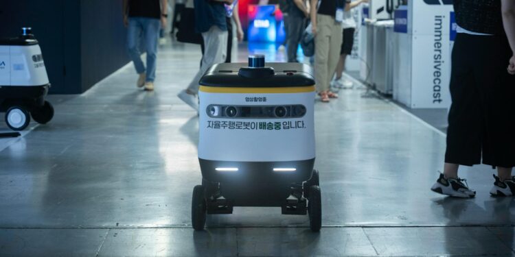 Alibaba team showcasing the new AI model Qwen 3.6-Max-Preview at a tech conference.