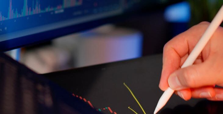 A financial analyst examines charts reflecting cryptocurrency market declines.