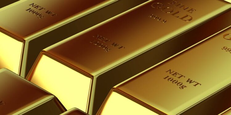 Gold bars stacked on a table, symbolizing falling gold prices amid economic uncertainty.
