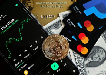 Shinhan Card and Solana logos with digital currency symbols and a financial chart backdrop.