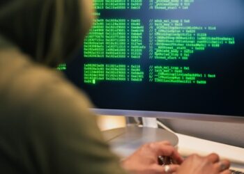 A hacker working on a computer, symbolizing the KelpDAO hack linked to Lazarus Group.