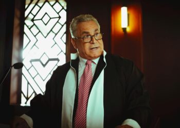 Sam Bankman-Fried speaking to a courtroom filled with reporters and legal officials.