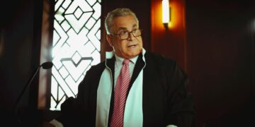 Sam Bankman-Fried speaking to a courtroom filled with reporters and legal officials.