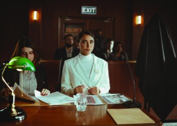 A courtroom scene with a judge, defendant, and lawyers discussing cryptocurrency fraud case.