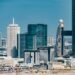 A Dubai skyline with financial district buildings and blockchain symbols overlaying the scene.