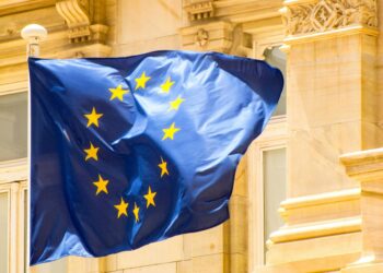 European Parliament building with EU flags, symbolizing regulatory challenges for Malta's iGaming.