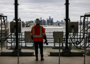Construction workers oversee the expansion of AI data centers at HIVE and Keel facility.