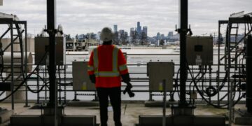 Construction workers oversee the expansion of AI data centers at HIVE and Keel facility.