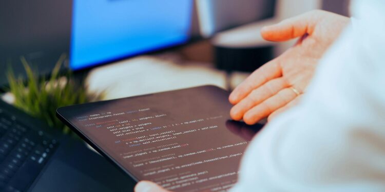 Developers collaborating on coding decentralized AI applications with blockchain elements.