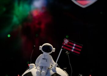 Mining Grid's team celebrates COREs evolution with a cake and cryptocurrency-themed decorations.