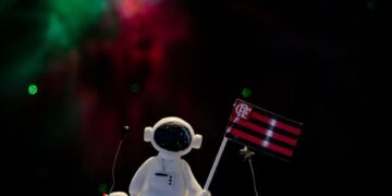 Mining Grid's team celebrates COREs evolution with a cake and cryptocurrency-themed decorations.