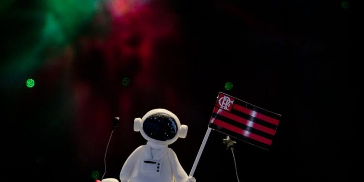 Mining Grid's team celebrates COREs evolution with a cake and cryptocurrency-themed decorations.