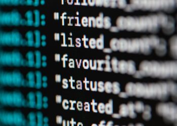 Computer screen displaying lines of code with a padlock symbol representing AI security concerns.