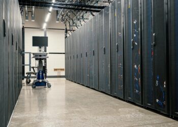 A digital rendering of a modern data center filled with AI server racks and circuitry.