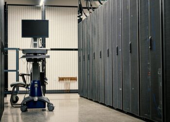 Bitcoin mining rigs operating in a high-tech facility with glowing screens and equipment.