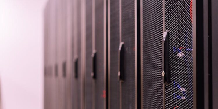 Aerial view of a large data center with servers and cooling systems, showcasing tech infrastructure.