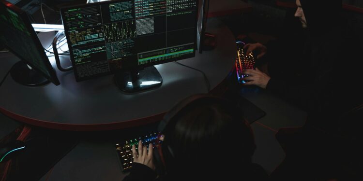 Security researchers analyzing code on a computer screen, focusing on vulnerabilities.