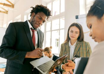 Kenyan fintech team discussing USDA stablecoin pilot project in a modern office setting.