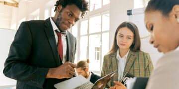 Kenyan fintech team discussing USDA stablecoin pilot project in a modern office setting.
