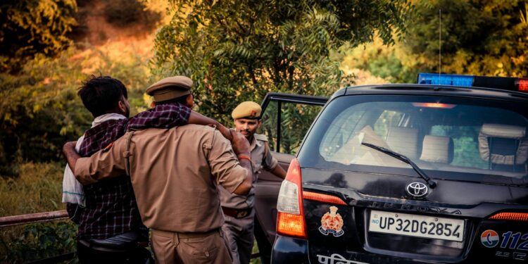 French police officers assist a distressed mother and child during a crypto ransom rescue operation.